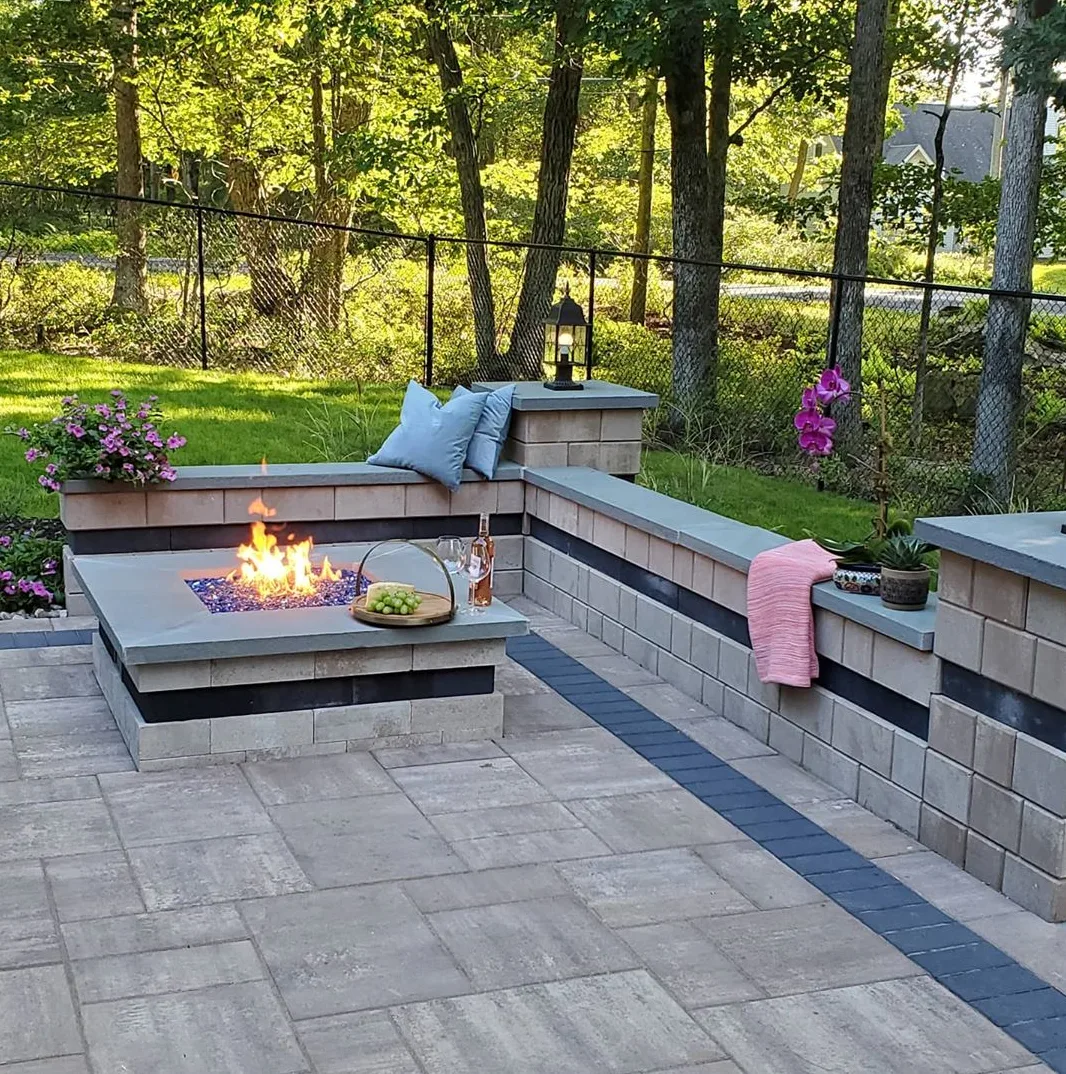 Finished patio with a built-in fire feature and seating walls
